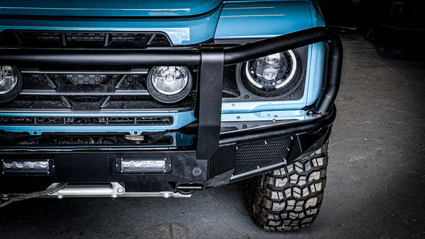 Close-up of the textured black powder coat finish on the INEOS Grenadier modular bullbar, showing precision laser-welded joints and auxiliary light mounts.